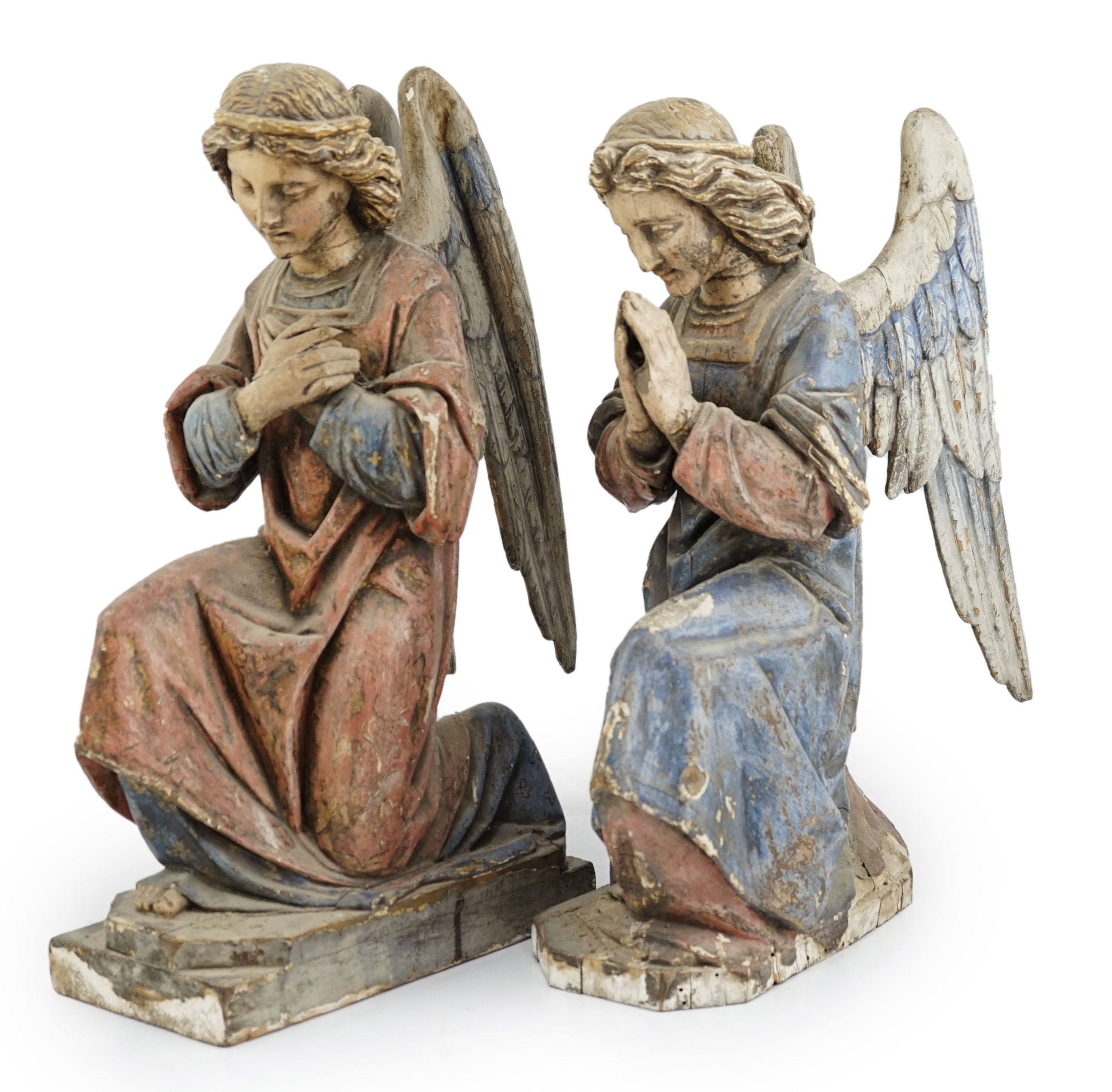 A pair of late 19th century polychrome carved painted pine praying archangels